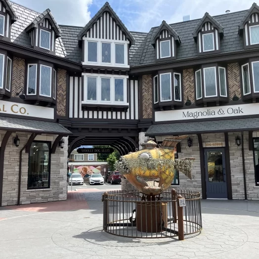 District 1881 courtyard showing a fish sculpture and walkway tunnel between shops